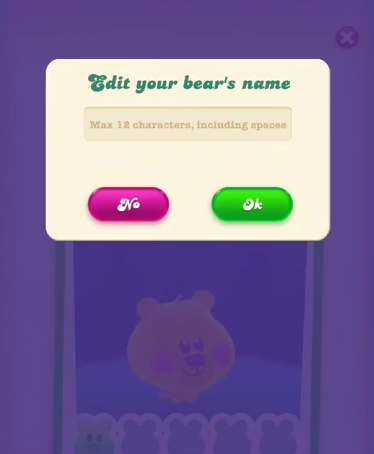 Pop-up in Candy Crush Soda Saga: "Bewerk de naam van je beer" De speler kan maximaal 12 tekens gebruiken, inclusief spaties. Daaronder een roze knop met de tekst "Nee" en een groene knop met de tekst "OK".